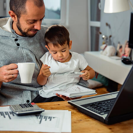 a man with a baby working remotely